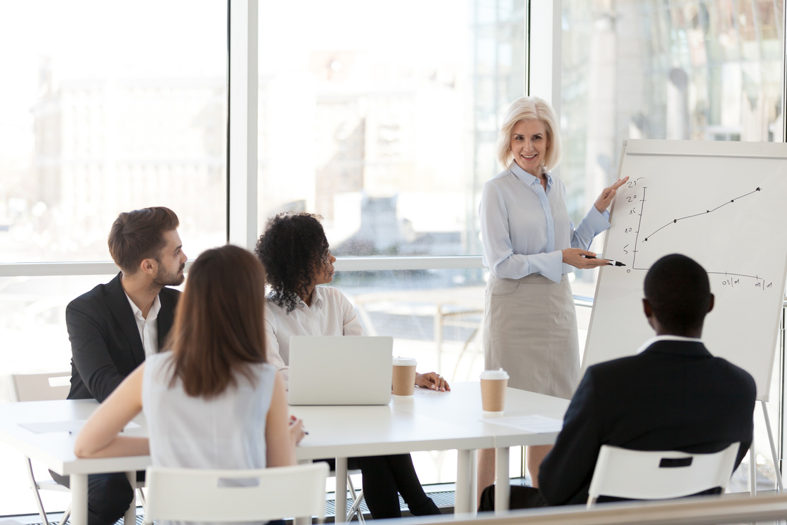 Middle aged female mentor train company employees